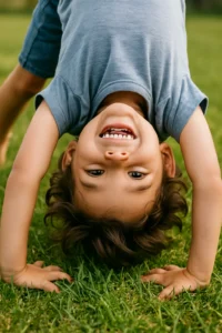 The Common Sense Guide to A Separation Agreement in Ontario 19 Smiling child doing a handstand in the grass, symbolizing support, balance, and care.